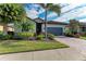 Single-Gathering home with gray garage door and palm trees at 6579 Willowshire Way, Bradenton, FL 34212