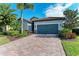 Single-story home with gray garage door and paver driveway at 6579 Willowshire Way, Bradenton, FL 34212