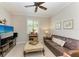 Spacious living area featuring a comfortable couch and large TV at 6579 Willowshire Way, Bradenton, FL 34212