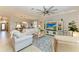 Bright and airy living room with comfortable seating and a view of the dining area at 6579 Willowshire Way, Bradenton, FL 34212