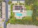 Community pool, shuffleboard, and building in an aerial view at 7117 27Th Ave Dr W # 7117, Bradenton, FL 34209