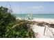 Beach access with a colorful umbrella and chairs at 7117 27Th Ave Dr W # 7117, Bradenton, FL 34209