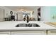 Modern kitchen with breakfast bar, stainless steel sink, and white cabinets at 7117 27Th Ave Dr W # 7117, Bradenton, FL 34209