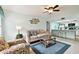 Bright living room featuring a beige sofa and a view into the kitchen at 7117 27Th Ave Dr W # 7117, Bradenton, FL 34209