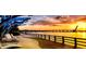 Scenic waterfront walkway at sunset with palm trees at 7117 27Th Ave Dr W # 7117, Bradenton, FL 34209