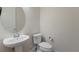 Small bathroom with toilet and pedestal sink at 712 Sigsbee Loop, Sarasota, FL 34240