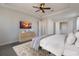 Bright bedroom with a large bed, dresser, and TV at 712 Sigsbee Loop, Sarasota, FL 34240