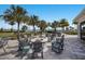 Relaxing fire pit area with seating and palm trees at 712 Sigsbee Loop, Sarasota, FL 34240