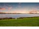 Scenic lakefront view with tranquil sunset at 712 Sigsbee Loop, Sarasota, FL 34240