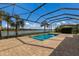 Screened-in pool with paver deck overlooking lake at 712 Sigsbee Loop, Sarasota, FL 34240