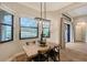 Bright breakfast nook with wooden table and chairs, offering a view of the golf course at 7312 Riviera Cv, Lakewood Ranch, FL 34202