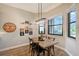 Bright breakfast nook with wooden table and chairs, offering a view of the backyard at 7312 Riviera Cv, Lakewood Ranch, FL 34202