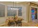 Bright dining area with rustic table and chairs, illuminated by a modern light fixture at 7312 Riviera Cv, Lakewood Ranch, FL 34202