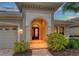 Elegant entryway with arched doorway, tile flooring, and decorative lighting at 7312 Riviera Cv, Lakewood Ranch, FL 34202