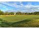 Beautiful golf course view with homes in the background at 7312 Riviera Cv, Lakewood Ranch, FL 34202