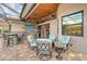 Covered patio with outdoor kitchen, seating area, and wood ceiling at 7312 Riviera Cv, Lakewood Ranch, FL 34202