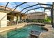 Enjoy this refreshing pool and spa with outdoor kitchen and seating area at 7312 Riviera Cv, Lakewood Ranch, FL 34202