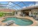 Resort-style pool with outdoor kitchen and covered patio at 7312 Riviera Cv, Lakewood Ranch, FL 34202