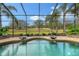 Stunning pool with screened enclosure overlooking a golf course at 7312 Riviera Cv, Lakewood Ranch, FL 34202