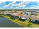 Aerial view of house with screened patio by lake at 7432 Summerland Cv, Lakewood Ranch, FL 34202