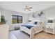 Bright bedroom with a white bed frame and blue accents at 7432 Summerland Cv, Lakewood Ranch, FL 34202