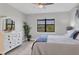 Bedroom with white dresser and a bed with blue blanket at 7432 Summerland Cv, Lakewood Ranch, FL 34202