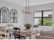 Elegant dining room with a farmhouse table and chandelier at 7432 Summerland Cv, Lakewood Ranch, FL 34202