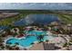 Resort-style pool area with lounge chairs and palm trees at 7432 Summerland Cv, Lakewood Ranch, FL 34202