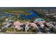 Aerial view of community clubhouse, pool, and tennis courts at 7575 Quinto Dr, Sarasota, FL 34238