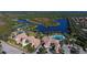 Aerial view of community with lake, tennis courts, and clubhouse at 7575 Quinto Dr, Sarasota, FL 34238