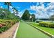 Landscaped bocce ball court near lake at 7575 Quinto Dr, Sarasota, FL 34238