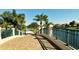 Brick paved path with green metal railing and palm trees lines the canal at 7575 Quinto Dr, Sarasota, FL 34238