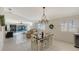 Dining area with chandelier and view of living room and pool at 7575 Quinto Dr, Sarasota, FL 34238