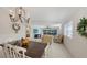 Farmhouse style dining table with chandelier and view into living room at 7575 Quinto Dr, Sarasota, FL 34238