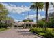 Gated community entrance with palm trees and brick road at 7575 Quinto Dr, Sarasota, FL 34238