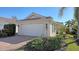 Single-story home with attached garage and landscaped front yard at 7575 Quinto Dr, Sarasota, FL 34238