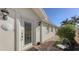 Front door entry with brick walkway and landscaping at 7575 Quinto Dr, Sarasota, FL 34238