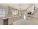 White kitchen with stainless steel appliances and an adjacent wine cooler at 7575 Quinto Dr, Sarasota, FL 34238