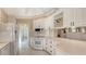 Clean kitchen features white cabinets, tile floors, and stainless steel appliances at 7575 Quinto Dr, Sarasota, FL 34238