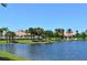 Serene lakefront view of clubhouse and gazebo at 7575 Quinto Dr, Sarasota, FL 34238