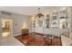 Built-in shelving, hardwood floors, and view of bathroom at 7575 Quinto Dr, Sarasota, FL 34238