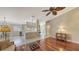 Hardwood floors, open layout to kitchen, and built-in shelving at 7575 Quinto Dr, Sarasota, FL 34238