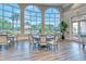 Bright clubhouse lobby with large windows and dining tables at 7575 Quinto Dr, Sarasota, FL 34238