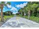 Paved trail with yellow center line and directional arrows, ideal for cyclists and pedestrians at 7575 Quinto Dr, Sarasota, FL 34238