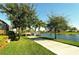 Scenic walkway along the lake with lush landscaping at 7575 Quinto Dr, Sarasota, FL 34238