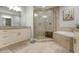 Spa-like bathroom with walk-in shower, soaking tub, and double vanity at 7910 34Th W Ave # 102, Bradenton, FL 34209