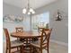 Charming dining room with round wooden table and chairs at 7910 34Th W Ave # 102, Bradenton, FL 34209