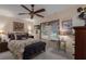 Bedroom with queen-size bed, ceiling fan, and built-in shelving at 8414 Imperial Cir, Palmetto, FL 34221