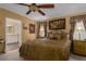 Spacious main bedroom with a king-size bed, ceiling fan, and large windows at 8414 Imperial Cir, Palmetto, FL 34221