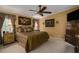 King-size bedroom with ceiling fan, large windows, and dark wood furniture at 8414 Imperial Cir, Palmetto, FL 34221